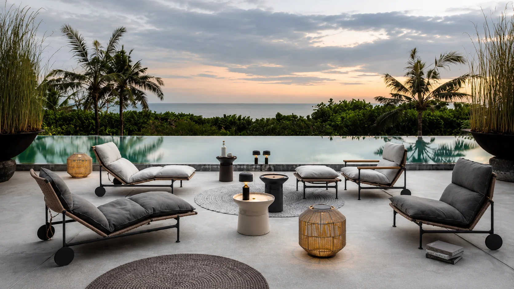 Gloster teak loungers by the pool at sunset